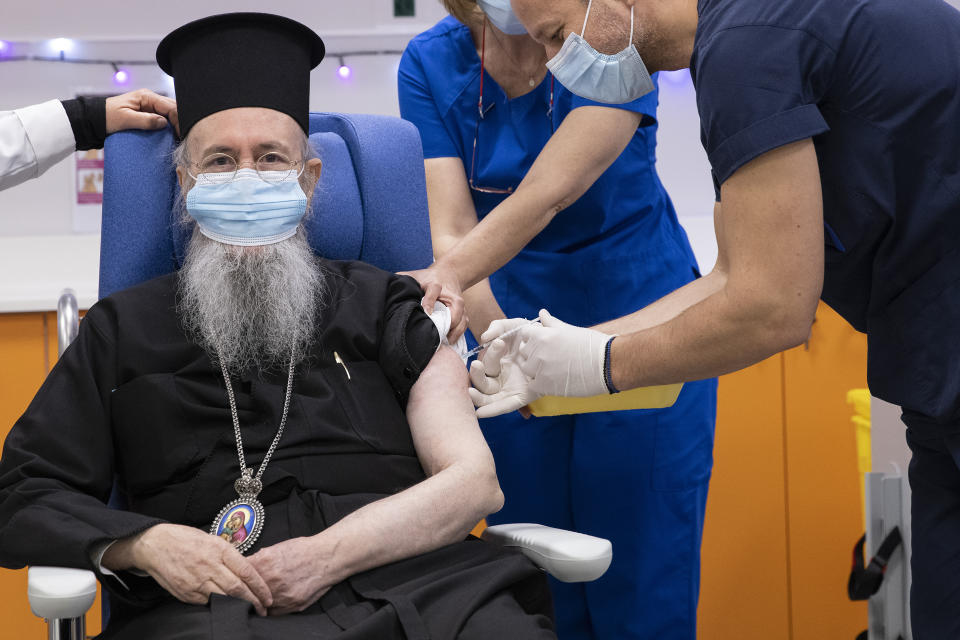 Metropolitan Hierotheos of Nafpaktos and Agios Vlasios receives an injection with a dose of COVID-19 vaccine, at Evangelismos hospital, in Athens, Sunday, Dec. 27, 2020. Doctors, nurses and the elderly rolled up their sleeves across the European Union to receive the first doses of the coronavirus vaccine Sunday in a symbolic show of unity and moment of hope for a continent confronting its worst health care crisis in a century. (Alkis Konstantinidis/Pool via AP)