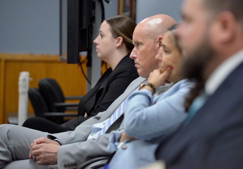 Cape and Islands District Attorney Robert Galibois, second from left, and First Assistant District Jessica Elumba, second from right, listens to Adrian Black's attorney, John Geary, speak during Black's arraignment on Tuesday in Falmouth District Court.