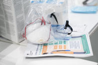 FILE - In this Thursday, April 16, 2020 file photo, a view of masks and goggles, part of PPE, personal protective equipment, to avoid being infected or transmitting coronavirus, at the Nightingale Hospital North West set up in the Manchester Central Convention Complex in Manchester, northern England. Britain's public spending watchdog says the government spent billions, without proper transparency, in a scramble to secure protective equipment early in the coronavirus outbreak. The National Audit Office says in a report Wednesday, Nov. 18, 2020 that companies with links to politicians were fast-tracked and had more chance of getting a contract than other applicants. Like many countries, the U.K. was caught without enough masks, gowns, gloves and other items to keep health care workers and the public safe as coronavirus cases skyrocketed.(AP Photo/Jon Super, File)