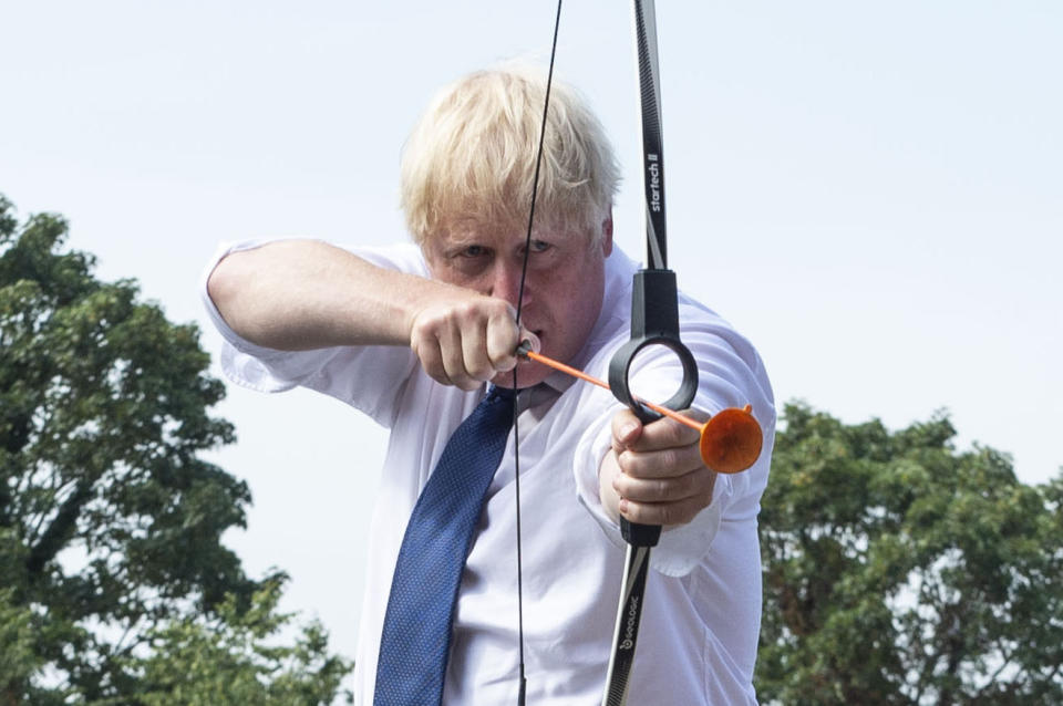 Prime Minister Boris Johnson takes part in archery during a visit to the Premier Education Summer Camp at Sacred Heart of Mary Girl's School, Upminster in Essex.