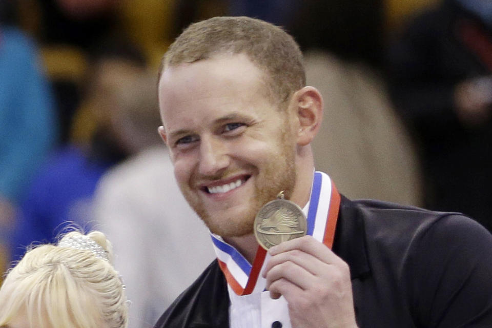 Bronze medalist John Coughlin smiles during a 2014 award ceremony at the U.S. Figure Skating Championships in Boston. Coughlin died by suicide in January amid an investigation into similar allegations of sexual misconduct by him. (Photo: ASSOCIATED PRESS)
