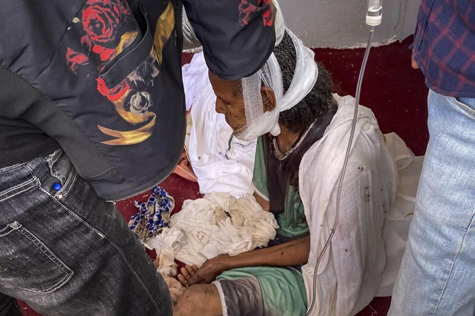 An elderly woman who fled to the city of Axum in the Tigray region of Ethiopia to seek safety sits with her head bandaged after being wounded during an attack on the city, Monday, Nov. 30, 2020. She later died of her wounds. As Ethiopia’s Tigray region slowly resumes telephone service after three months of conflict, witnesses gave The Associated Press a detailed account of what might be its deadliest massacre, at the sacred Ethiopian Orthodox church in Axum. (AP Photo)