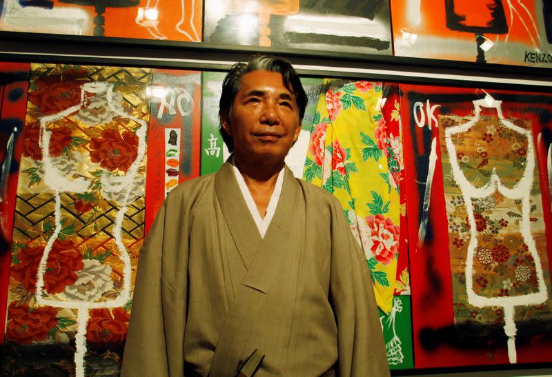 FILE PHOTO: Japanese designer Kenzo poses for the media in front of his works at an art gallery in Buenos Aires