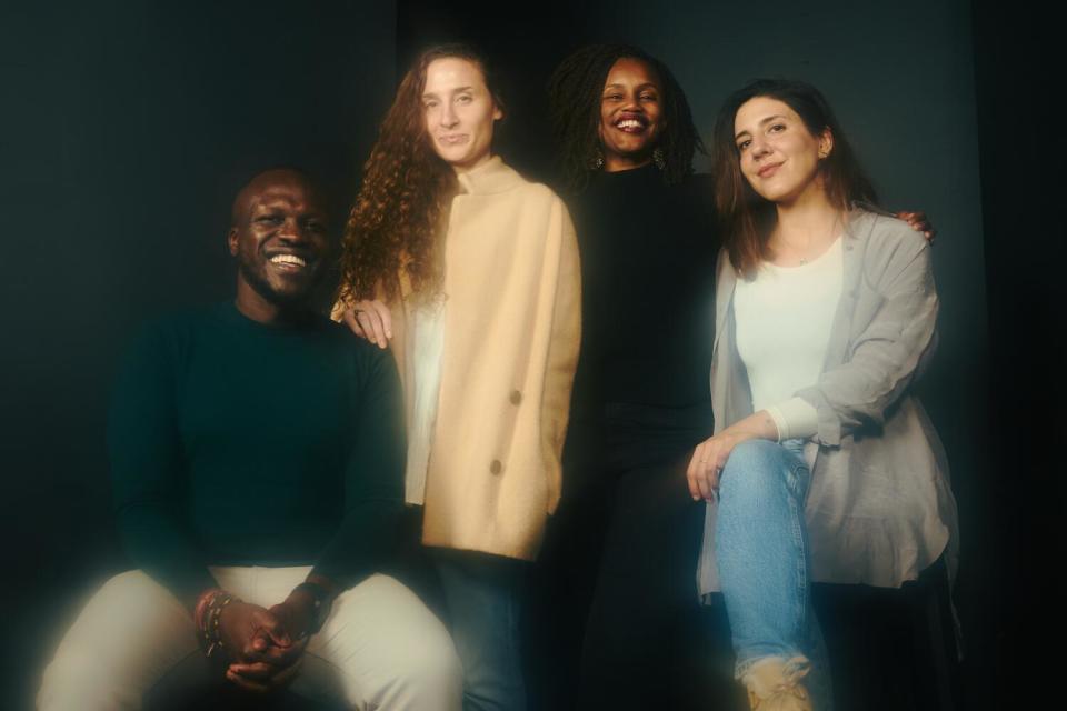 Four people pose for a portrait.