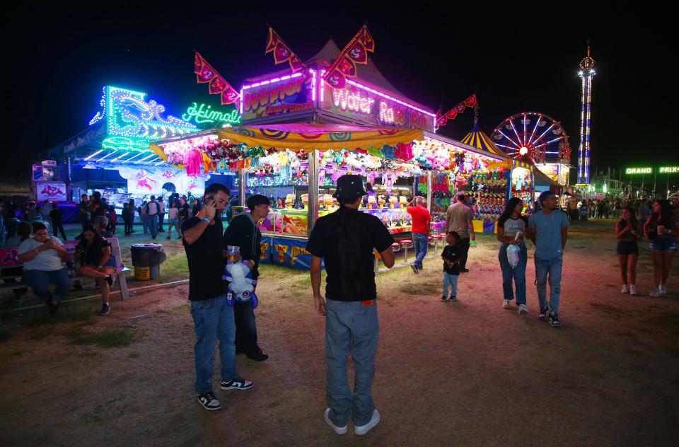 The glow of the midway at the Tulare County Fair in Tulare, Calif., Thursday, Sept. 15, 2022.