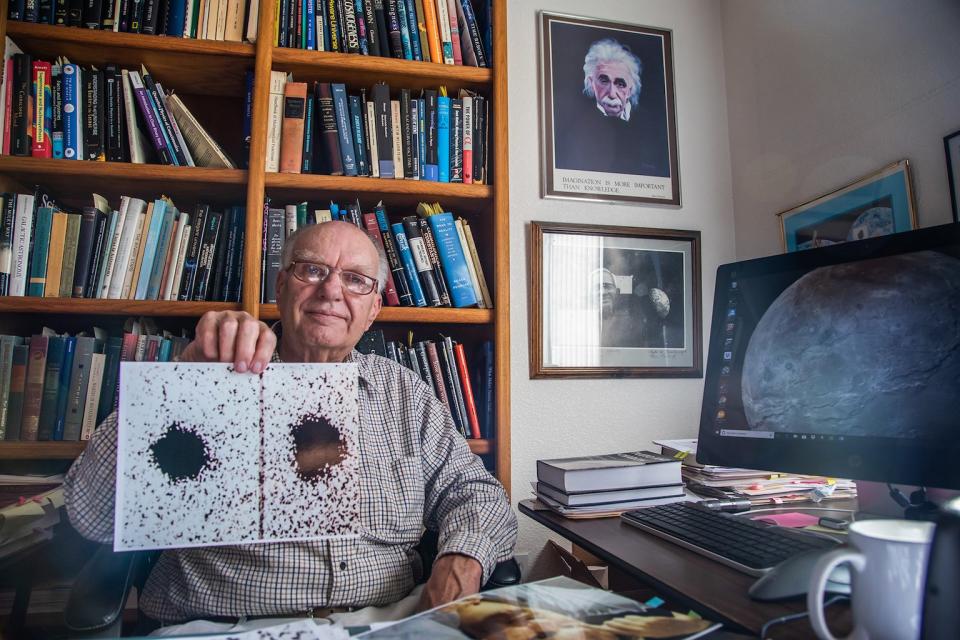 Forty years after Charon's discovery, Jim Christy holds up two of the telescope images he used to identify Pluto's largest moon in June 1978. A close-up of the moon, captured by New Horizons, is on his computer. <cite>NASA/Johns Hopkins University Applied Physics Laboratory/Southwest Research Institute/Art Howard/GHSPi</cite>