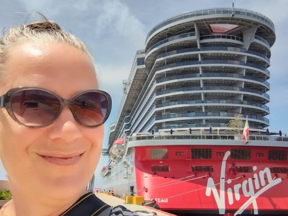woman smiling with virgin voyages cruise ship
