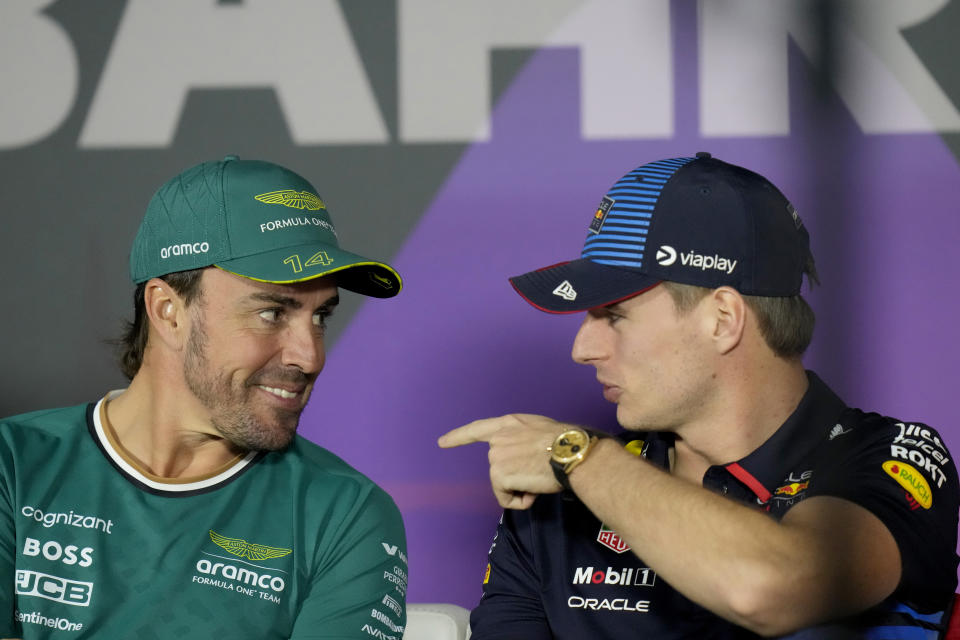 Aston Martin driver Fernando Alonso of Spain, left, speaks with Red Bull driver Max Verstappen of the Netherlands during a media conference ahead of the Formula One Bahrain Grand Prix at the Bahrain International Circuit in Sakhir, Bahrain, Wednesday, Feb. 28, 2024. (AP Photo/Darko Bandic)