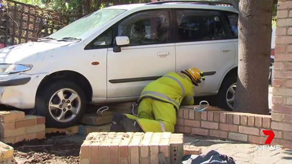 Emergency services work to free the trapped woman. Source: 7 News