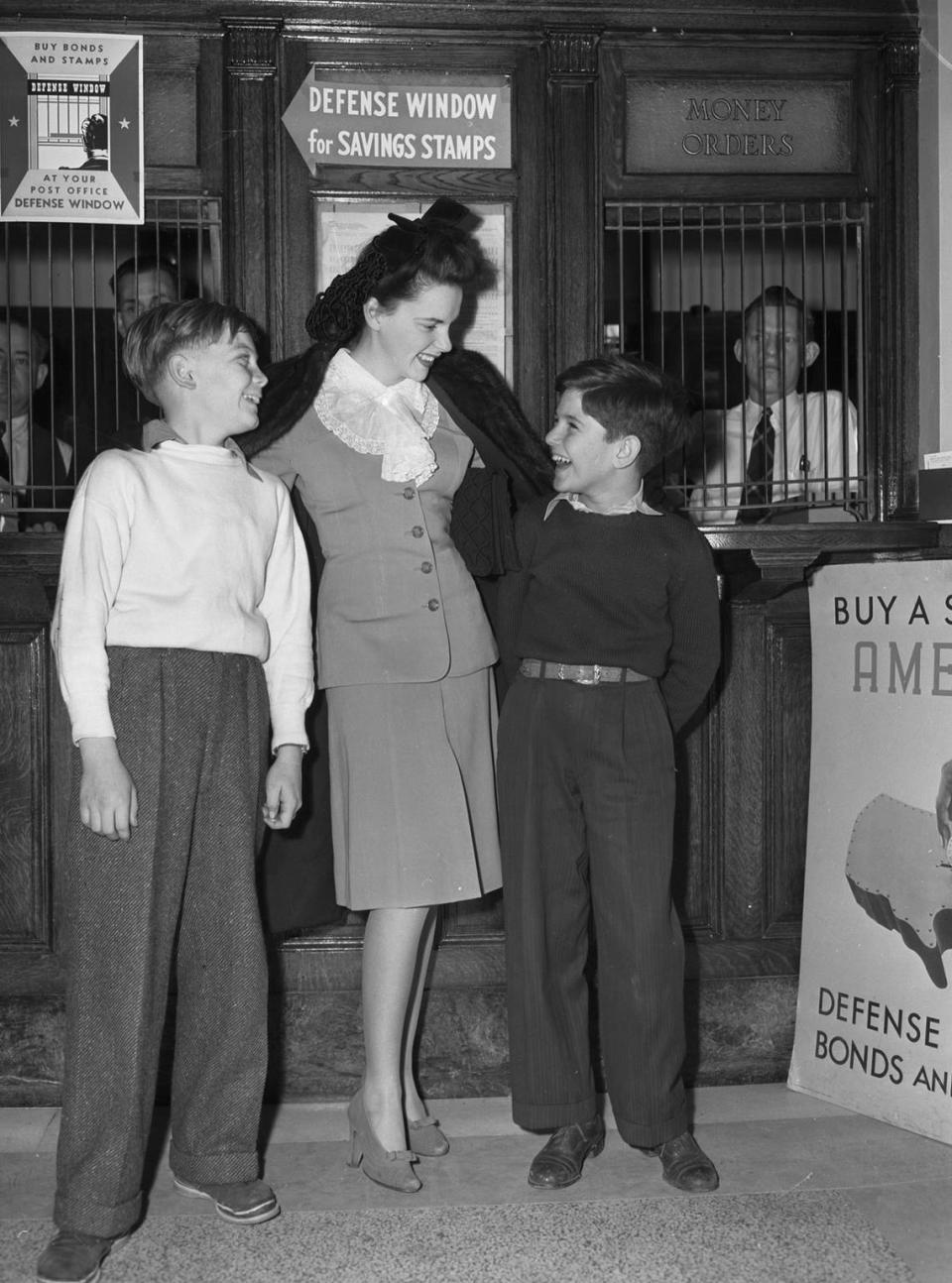 Jan. 30, 1942: Judy Garland is in Mineral Wells to visit Camp Wolters for a USO show. She poses with two of her admirers, Billy Suddith, left, and Herbert Cohen of Mineral Wells. Miss Garland led a parade of 2,000 school children to the post office to purchase stamps. Fort Worth Star-Telegram archives/UT Arlington Special Collections