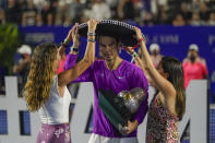 A sombrero is placed on the head of Spain's Rafael Nadal after defeating Britain's Cameron Norrie in the final match at the Mexican Open tennis tournament in Acapulco, Mexico, Saturday, Feb. 26, 2022. (AP Photo/Eduardo Verdugo)