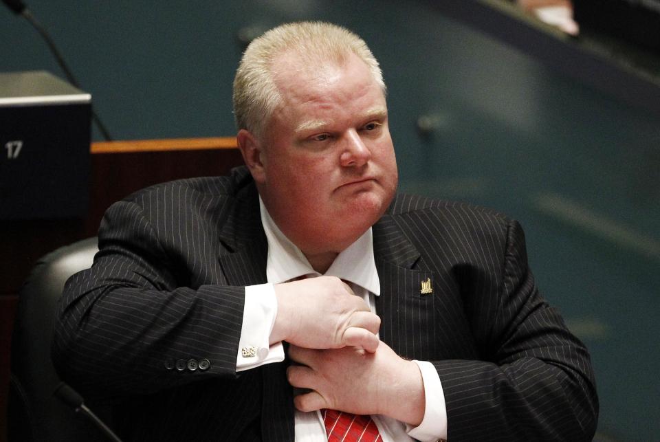 Toronto Mayor Rob Ford adjusts his tie during a special council meeting at City Hall in Toronto