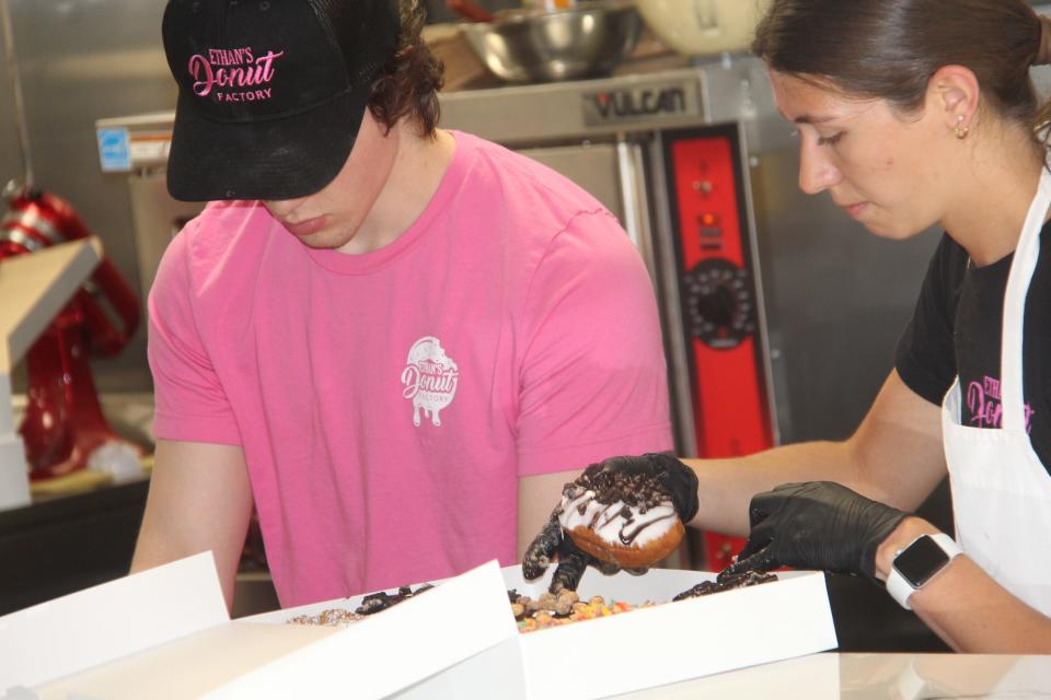 Staff at Ethan's Donut Factory in Hillsdale prepare a customer's order Wednesday.