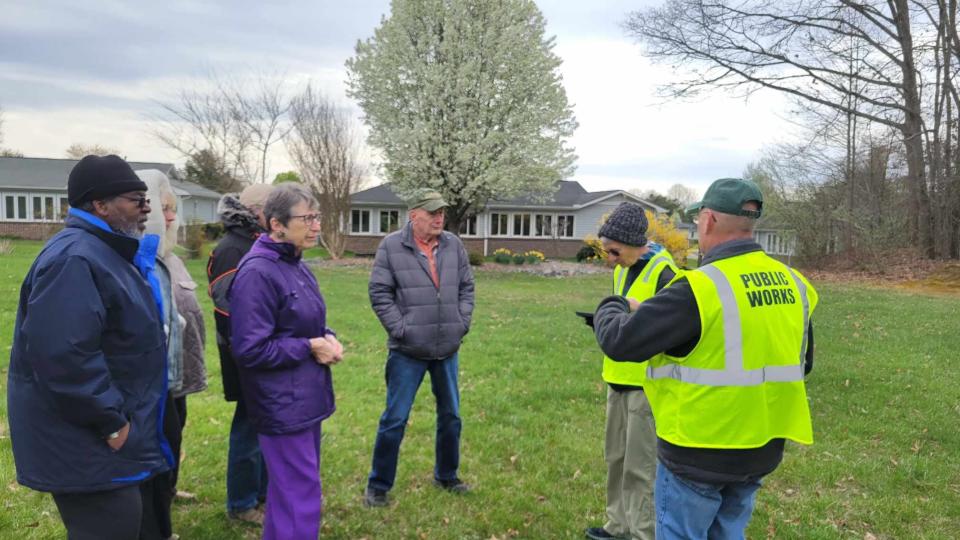 Hendersonville Tree Board members Glenn Lange, right, and Mary Davis talk with residents who live next to the property at the Blue Ridge Mall, where developers are hoping to build an extended-stay hotel.