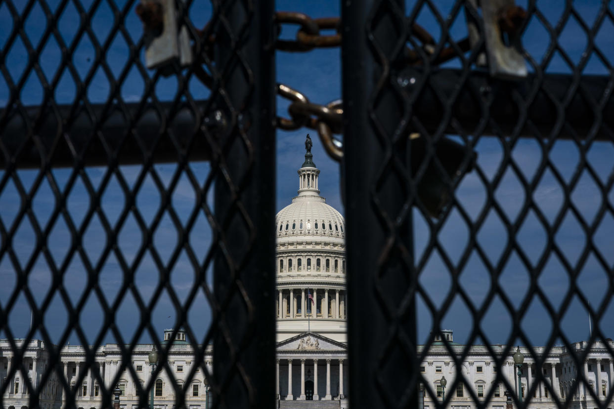 The U.S. Capitol, with a metal fence in the foreground.