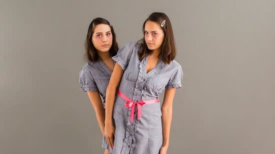 two women dressed the shining twins for an 80s halloween costume