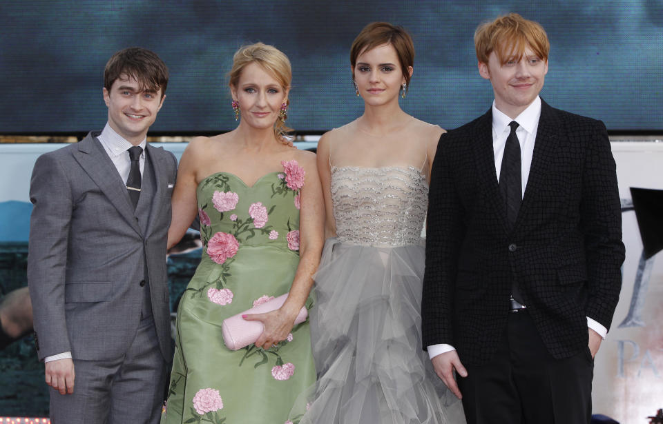 British author JK Rowling, second left, joins actors, left to right, Daniel Radcliffe, Emma Watson and Rupert Grint in Trafalgar Square, central London, for the World Premiere of "Harry Potter and the Deathly Hallows: Part 2" the last film in the series, Thursday, July 7, 2011. Harry Potter's saga is ending, but his magic spell remains. Thousands of fans from around the world massed in London Thursday for the premiere of the final film in the magical adventure series. (AP Photo/Joel Ryan)