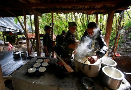 Members of the 51st Front of the Revolutionary Armed Forces of Colombia (FARC) prepare food at a camp in Cordillera Oriental, Colombia, August 16, 2016. REUTERS/John Vizcaino