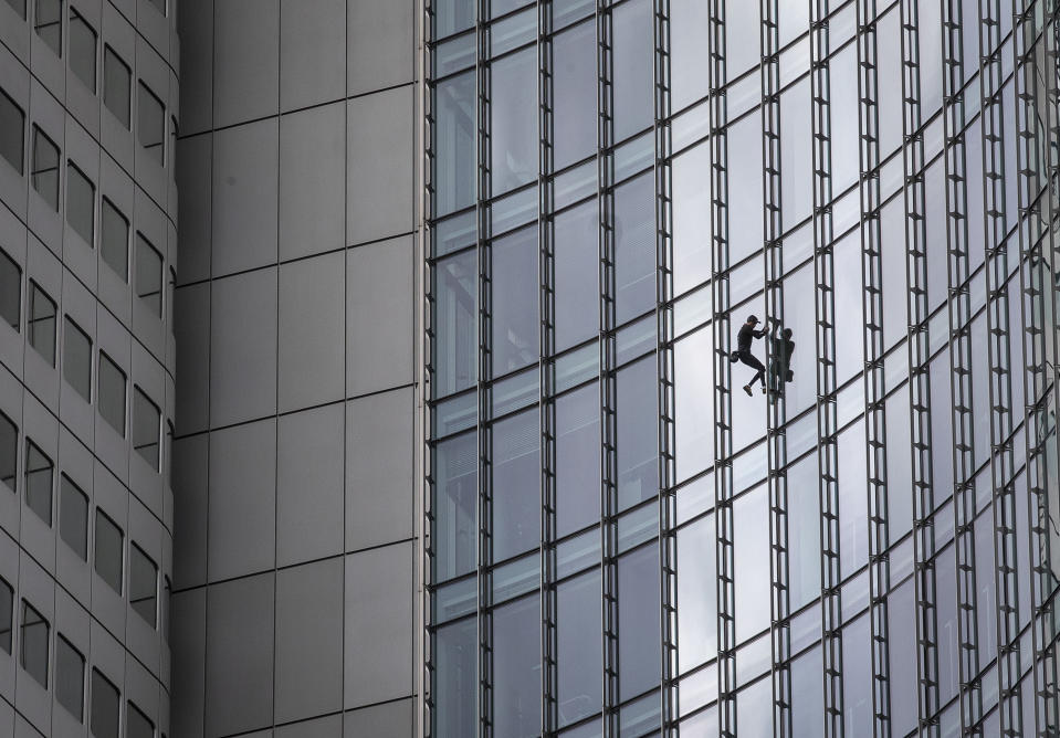 French urban climber Alain Robert, well known as "Spiderman", climbs down the 'Skyper' highrise in Frankfurt, Germany, Saturday, Sept. 28, 2019. (AP Photo/Michael Probst)