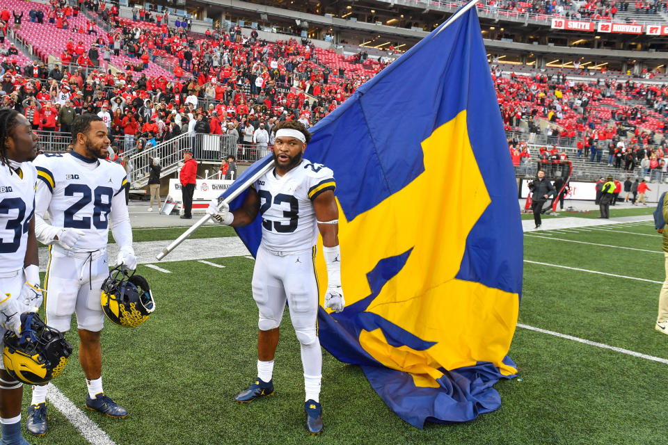 Michigan linebacker Michael Barrett celebrates with the University of Michigan flag after beating Ohio State at Ohio Stadium on November 26, 2022 in Columbus, Ohio. (Photo by Aaron J. Thornton/Getty Images)