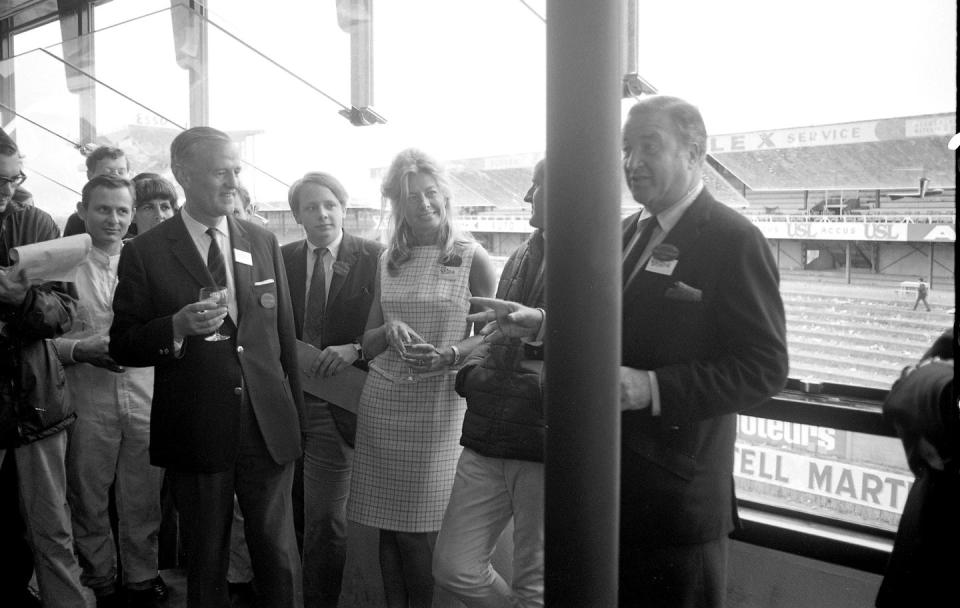 the victory celebration edsel ford, then 17, with his father, ceo henry ford ii far right and race winner bruce mclaren second from left, among others