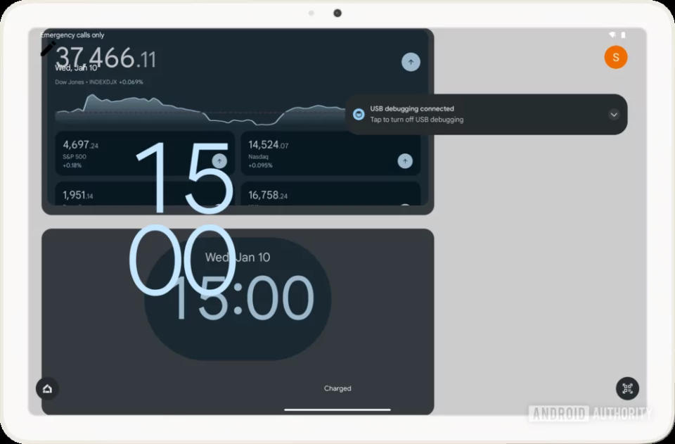 The Pixel Tablet showing a mashup of the lock screen with a clock and user icons, and widgets for another clock app and an app tracking stock prices.