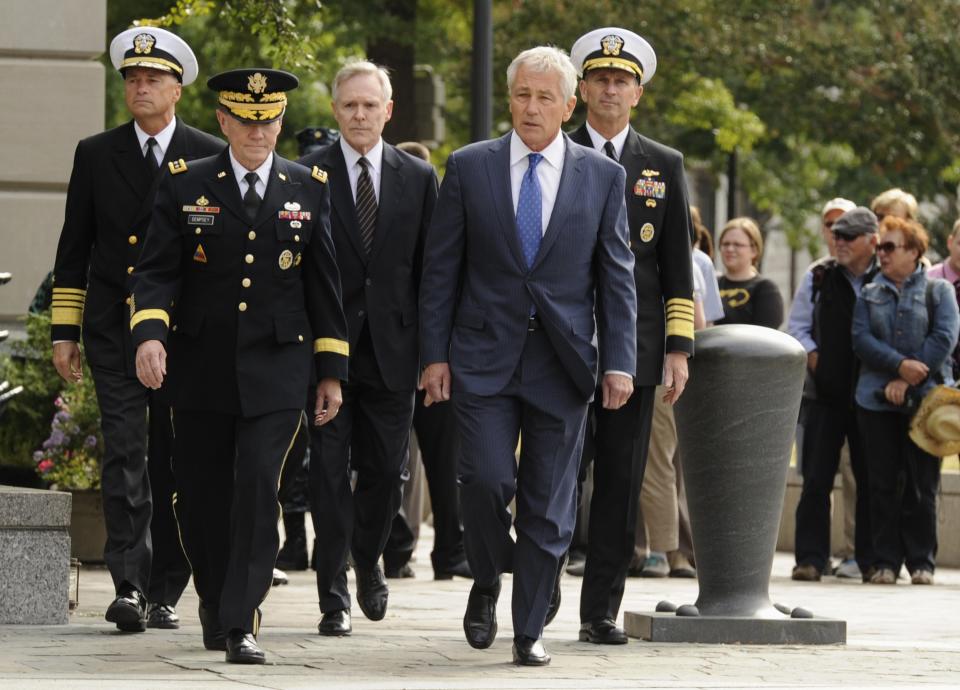 From L-R: Vice Chairman of the Joint Chiefs Adm. Sandy Winnefeld, Chairman of the Joint Chiefs Gen. Martin Dempsey, Navy Secretary Ray Mabus, Defense Secretary Chuck Hagel and Chief of Naval Operations Adm. Jonathan Greenert arrive at a ceremony at the Navy Memorial in Washington, honoring the victims of an attack at the Navy Yard, at the Navy Memorial in Washington, September 17, 2013. Washington authorities questioned on Tuesday how a U.S. military veteran with a history of violence and mental problems could have gotten clearance to enter a Navy base where he killed 12 people before police shot him dead. The suspect, Aaron Alexis, 34, a Navy contractor from Fort Worth, Texas, entered Washington Navy Yard on Monday morning and opened fire, spreading panic at the base just a mile and a half (2.5 km) from the U.S. Capitol and three miles (4.8 km) from the White House. (REUTERS/Mike Theiler)