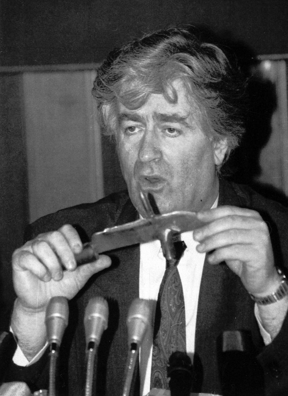 FILE - In this Sept. 23, 1992 file photo, Bosnian Serb leader Radovan Karadzic holds a knife he said was seized from Bosnian Croat soldiers in Bosnia during a news conference in Belgrade, Yugoslavia. Nearly a quarter of a century since Bosnia’s devastating war ended, former Bosnian Serb leader Radovan Karadzic is set to hear the final judgment on whether he can be held criminally responsible for unleashing a wave of murder and destruction during Europe’s bloodiest carnage since World War II. United Nations appeals judges on Wednesday March 20, 2019, will decide whether to uphold or overturn Karadzic’s 2016 convictions for genocide, crimes against humanity and war crimes and his 40-year sentence. (AP Photo/File)