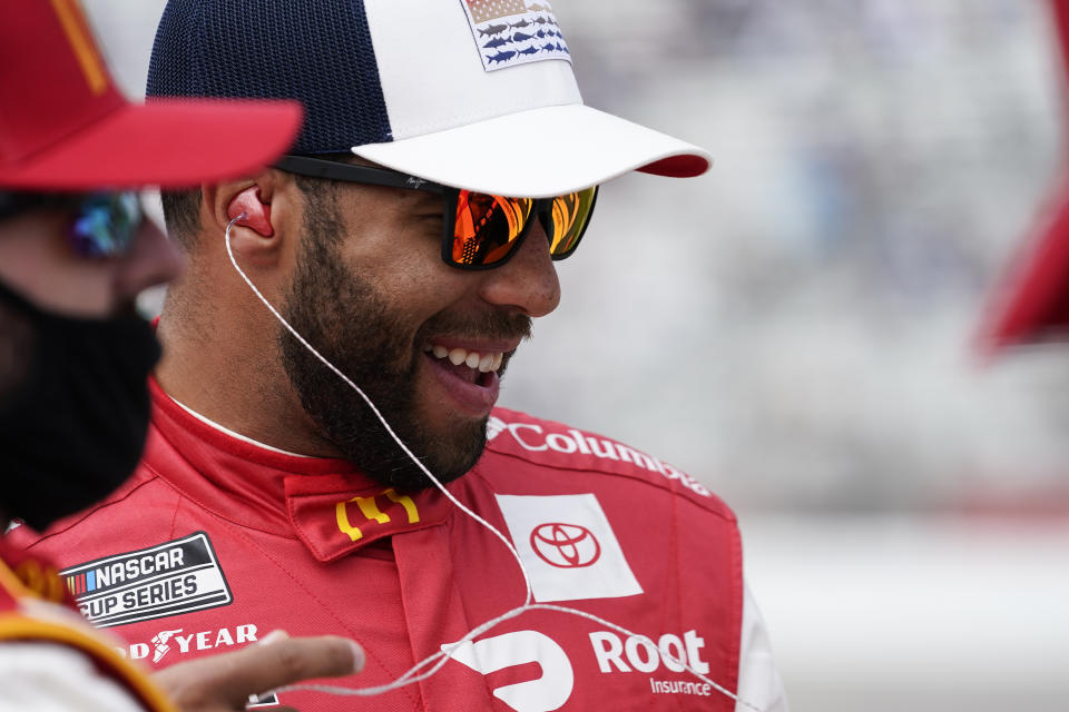 NASCAR Cup Series driver Bubba Wallace, laughs before a NASCAR Cup Series at Atlanta Motor Speedway on Sunday, March 21, 2021, in Hampton, Ga. (AP Photo/Brynn Anderson)