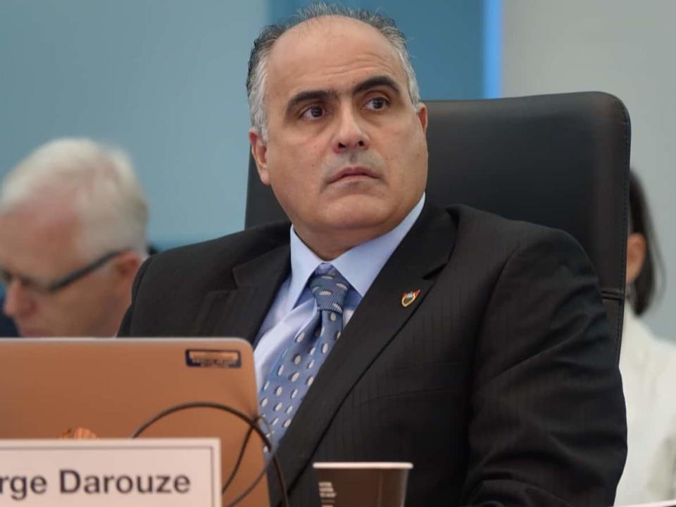 Osgoode Coun. George Darouze listens during a committee meeting May 10, 2019. A lawsuit against him by two constituents has been dropped, his lawyer confirmed. (Laura Osman/CBC - image credit)