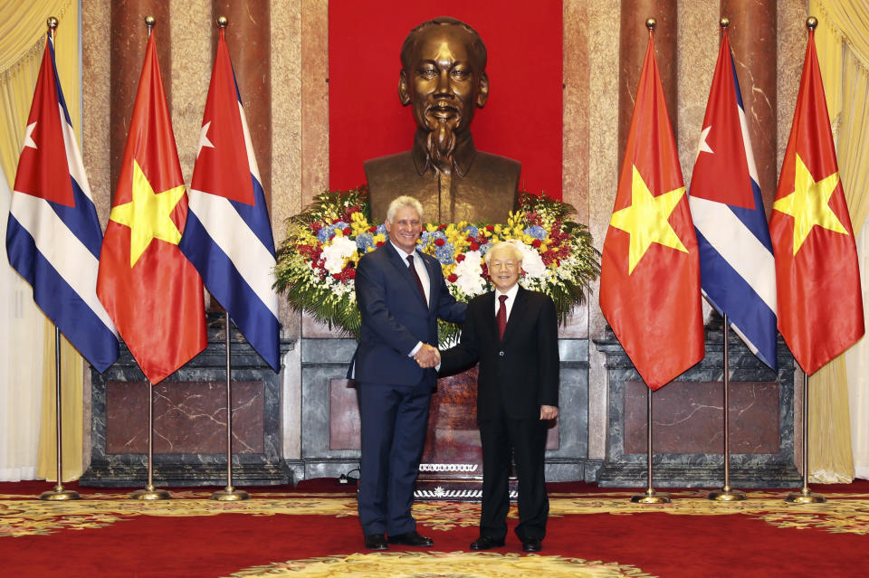 Vietnamese President Nguyen Phu Trong, right, shakes hands with his Cuban counterpart Miguel Diaz-Canelin in Hanoi, Vietnam, Friday, Nov. 9, 2018. Diaz-Canel is on a three-day visit to Vietnam to boost ties between the two Communist allies and part of his first international tour since taking office in April (Tri Dung/ Vietnam News Agency via AP)