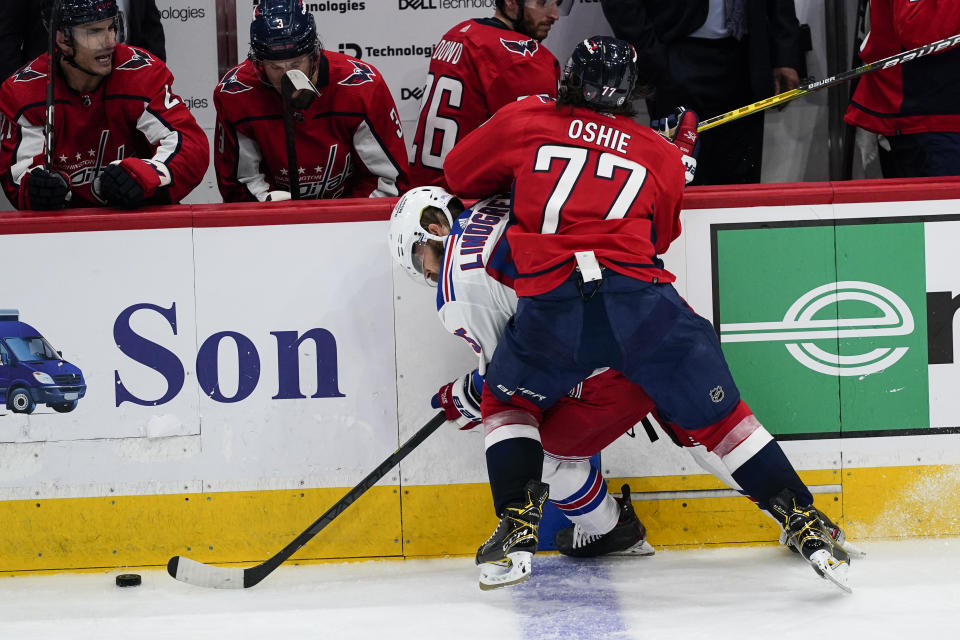 New York Rangers defenseman Ryan Lindgren (55) and Washington Capitals right wing T.J. Oshie (77) collide in the third period of an NHL hockey game, Wednesday, Oct. 13, 2021, in Washington. The Capitals won 5-1. (AP Photo/Alex Brandon)