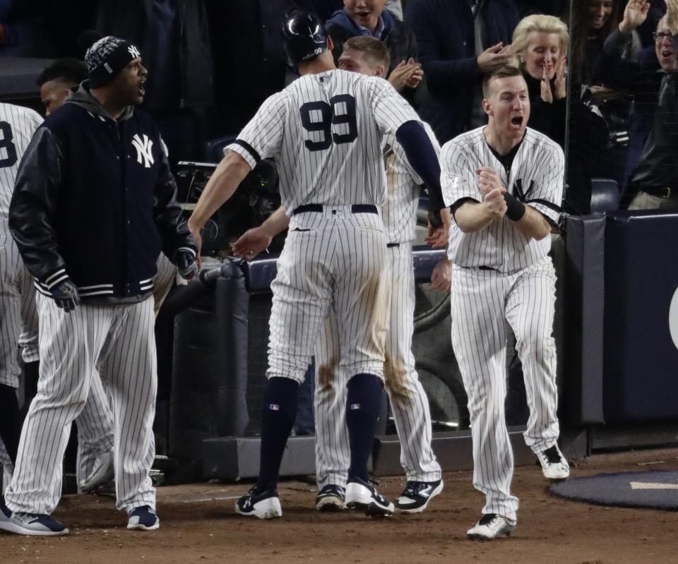 The Yankees’ Todd Frazier celebrates after Aaron Judge scored during the eighth inning Tuesday. (AP)