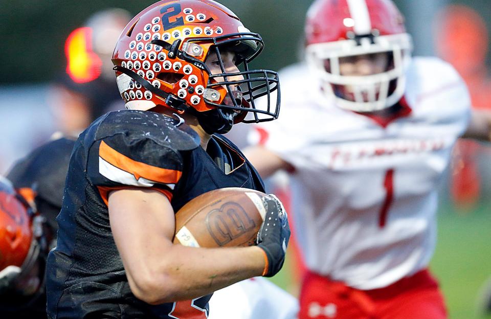 Lucas High School's Logan Toms (2) carries the ball against Plymouth High School during high school football action at Lucas High School Friday, Oct. 6, 2023. TOM E. PUSKAR