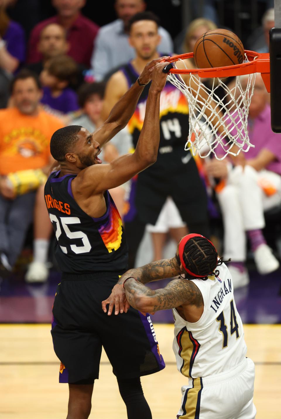 Apr 26, 2022; Phoenix, Arizona, USA; Phoenix Suns forward Mikal Bridges (25) dunks the ball against the New Orleans Pelicans in the second half during game five of the first round for the 2022 NBA playoffs at Footprint Center.