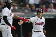 Cleveland Guardians' Steven Kwan, right, is congratulated by Josh Bell after scoring against the Boston Red Sox during the first inning of a baseball game Tuesday, June 6, 2023, in Cleveland. (AP Photo/Sue Ogrocki)
