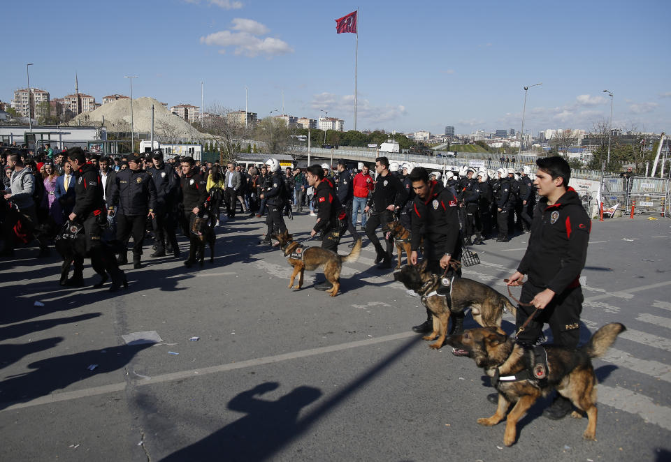 Police officers stand by as thousands of supporters of pro-Kurdish Peoples' Democratic Party, or HDP, gather to celebrate the Kurdish New Year and to attend a campaign rally for local elections that will test the Turkish president's popularity, in Istanbul, Sunday, March 24, 2019. The HDP held the event amid the municipal office races that have become polarizing and a government crackdown on its members for alleged links to outlawed Kurdish militants. (AP Photo/Emrah Gurel)