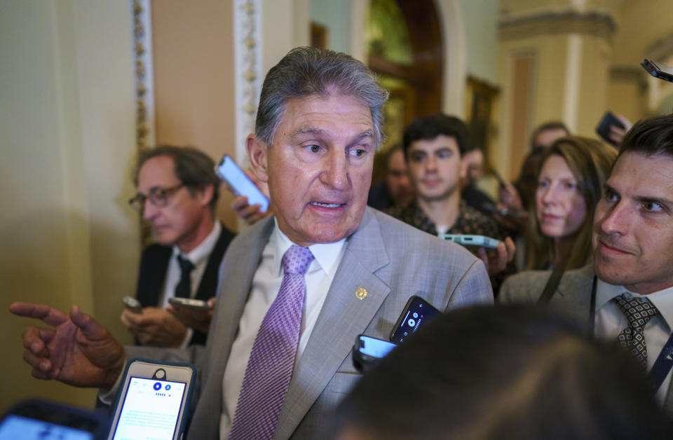 Sen. Joe Manchin, D-W.Va., a key negotiator in the infrastructure talks, is surrounded by reporters as walks through the Capitol in Washington, Tuesday, July 13, 2021. (AP Photo/J. Scott Applewhite)