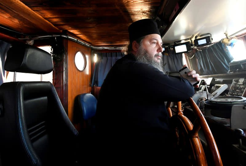 Father Abbot Abibos looks out the window from the wheelhouse of a mobile Georgian Orthodox monastery in Vlissingen