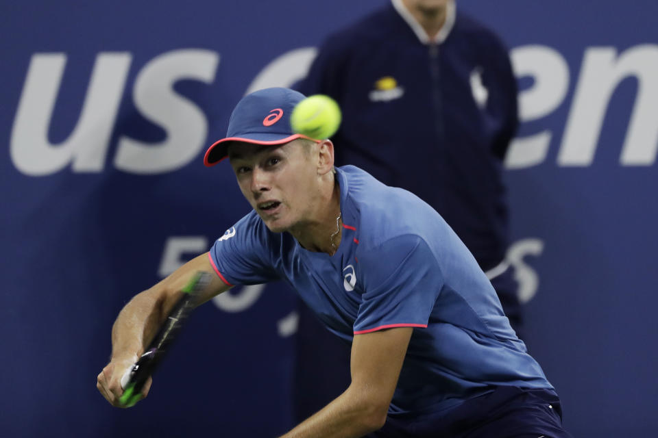 Alex de Minaur, of Australia, returns a shot against Marin Cilic, of Croatia, in a third-round match at the U.S. Open tennis championship, Saturday, Sept. 1, 2018, in New York. (AP Photo/Mark Lennihan)