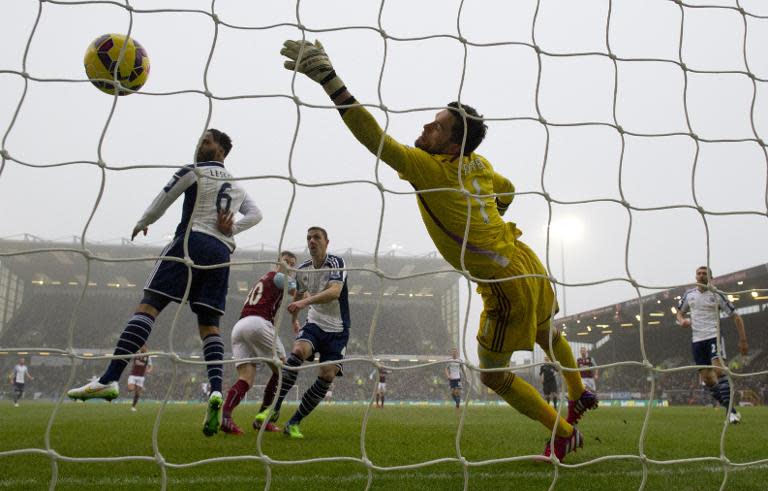 West Bromwich Albion's goalkeeper Ben Foster fails to stop Burnley's Ashley Barnes (2nd L) scoring a goal in their English Premier League match at Turf Moor in Burnley, north-west England, on February 8, 2015