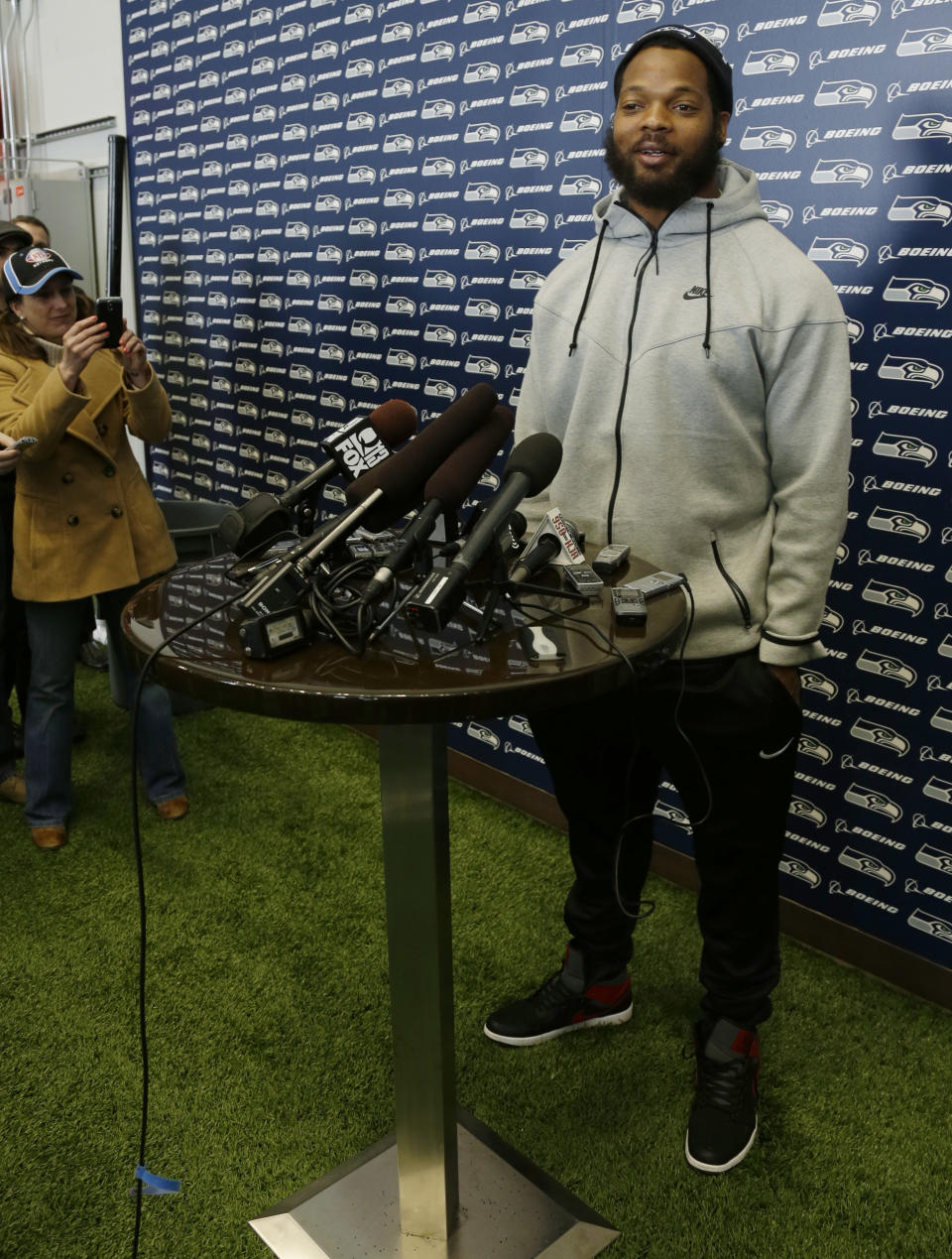 Seattle Seahawks defensive end Michael Bennett talks to reporters Monday, March 10, 2014, at the team's headquarters in Renton, Wash. The Seahawks announced Monday that Bennett, who was one of the top NFL football free agents this year, had signed a multi-year deal with the Super Bowl champion Seahawks. (AP Photo/Ted S. Warren)