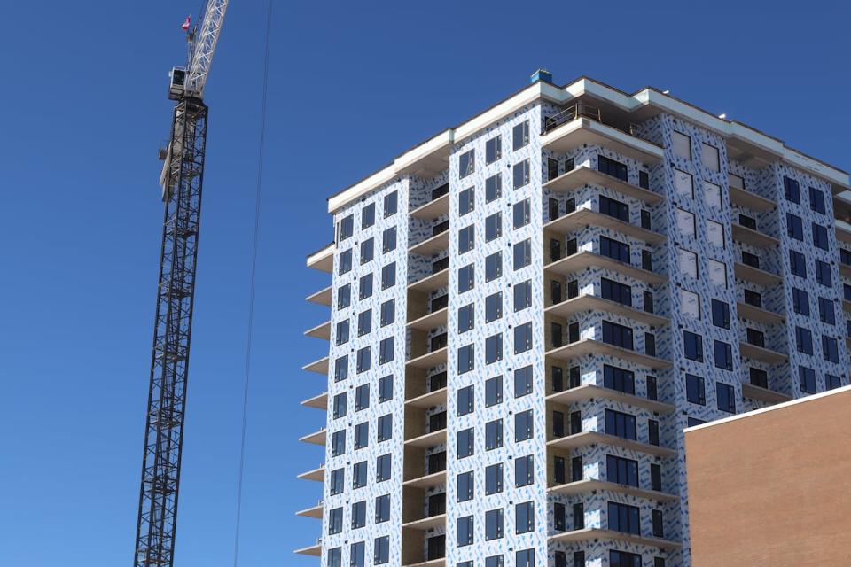 Hundreds of new homes are being built in New Brunswick's cities, like this tower in Moncton, but development is struggling to keep up with demand. Market pressures are also causing the province to lose affordable housing units.