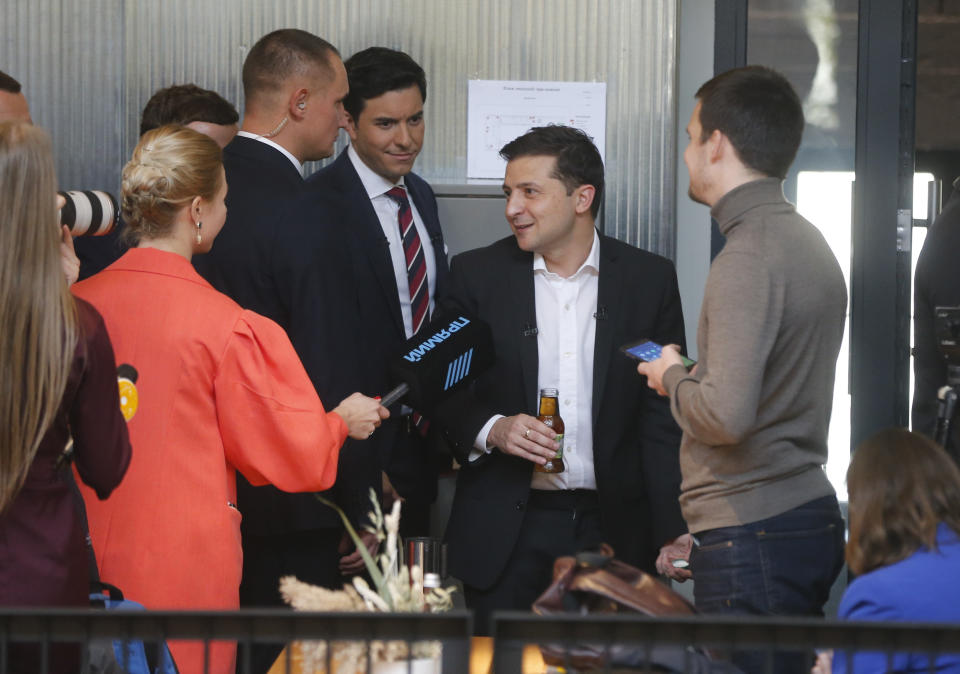 Ukrainian President Volodymyr Zelenskiy speaks with journalists during in an all-day "media marathon" held in a food court in Kyiv, Ukraine, Thursday, Oct. 10, 2019. Ukrainian President is holding an all-day "media marathon" in a Kyiv food court amid growing questions about his actions as president. (AP Photo/Efrem Lukatsky)