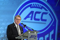 FILE - In this July 17, 2019, fil photo, Commissioner John Swofford speaks during the Atlantic Coast Conference NCAA college football media day in Charlotte, N.C. There are 130 major college football teams, spread across 41 states and competing in 10 conferences, save for a handful of independents. The goal is to have all those teams start the upcoming season at the same time — whether that's around Labor Day as scheduled or later — and play the same number of games. (AP Photo/Chuck Burton, File)