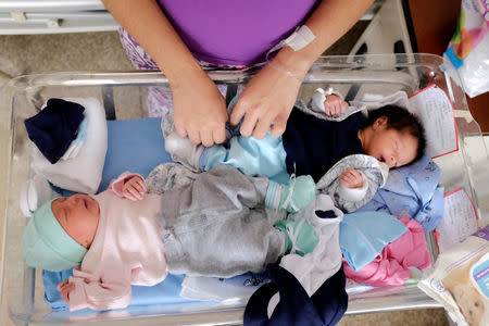 Fabilet Vargas takes care of her twins Matheo and Mayha at the Concepcion Palacios Hospital in Caracas, Venezuela September 13, 2018. Picture taken September 13, 2018. REUTERS/Marco Bello