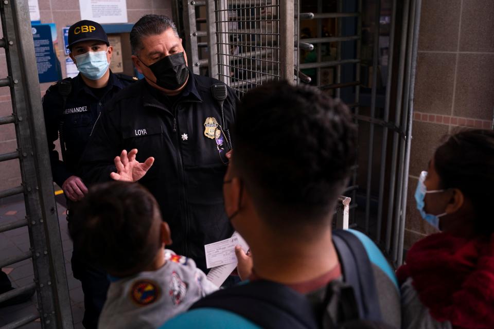 Nancy and Leo, along with their two children Alexander, 3, and Gael, 1, speak with a Border Patrol officer while seeking asylum at the U.S. Customs and Border Protection - Dennis DeConcini Port of Entry on Nov. 8, 2021, in Nogales, Mexico. The family, which has faced threats and harassment in Guerrero, Mexico, asked to omit their last names.