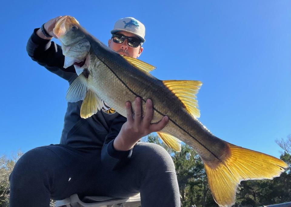 Cam Jergens shows off a 35-inch snook he caught in the Tomoka River.