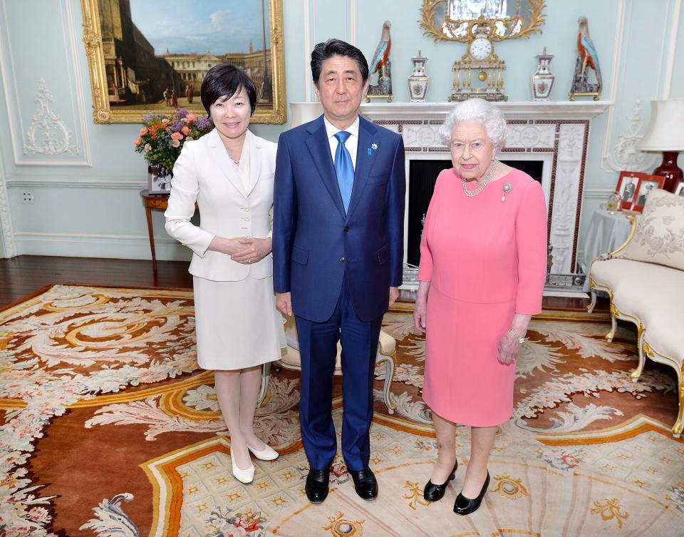 Britain's Queen Elizabeth II (R) hosts a private audience with Japanese Prime Minister Shinzo Abe, and his wife Akie
