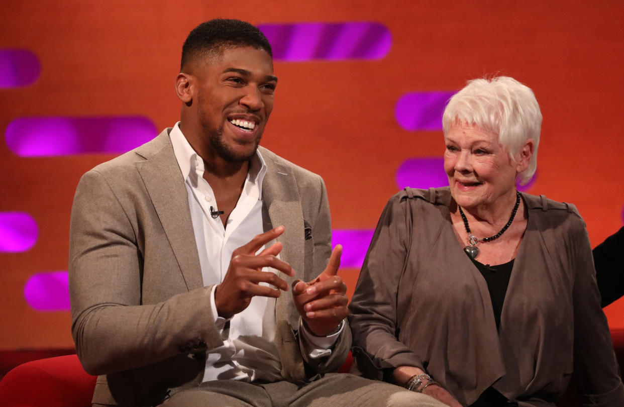 Anthony Joshua and Dame Judi Dench during the filming of the Graham Norton Show at BBC Studioworks 6 Television Centre, Wood Lane, London. (Photo by Isabel Infantes/PA Images via Getty Images)